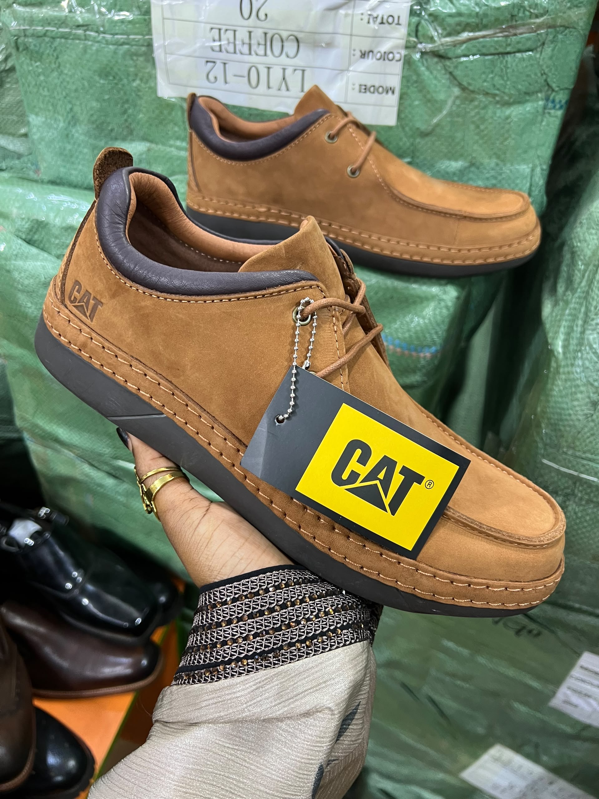 Men's casual low-cut shoes featuring a moc-toe stitch design and the iconic CAT logo branding.
Available in shades such as Coffee and Tan.
Crafted from soft nubuck leather with a dark contrast padded collar, durable flat rubber outsoles, and visible stitching details