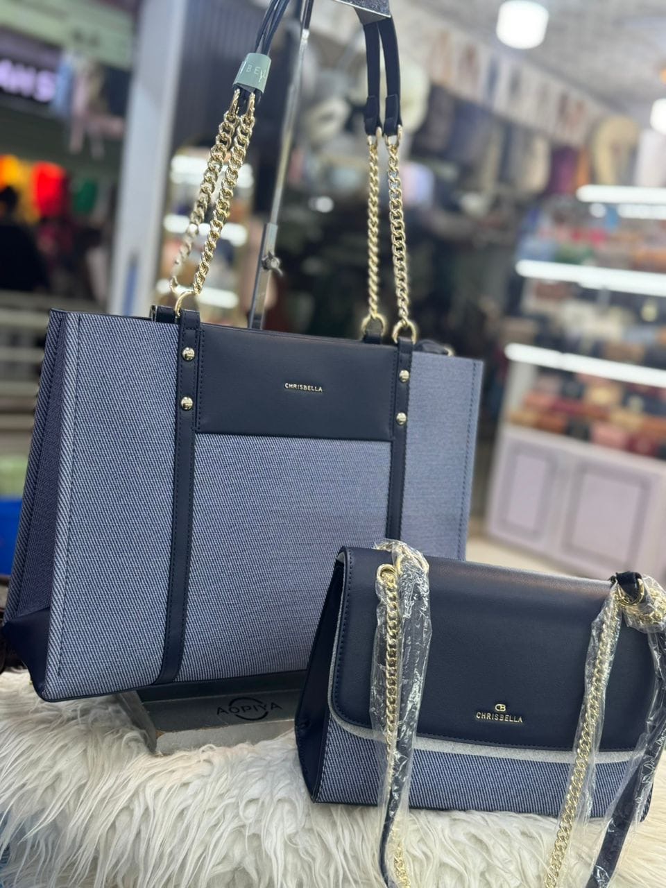 Chrisbella 2-in-1 Structured Tote & Companion Bag Set. Features a premium textured canvas body with smooth faux-leather trim and polished gold-tone hardware, a spacious structured office tote paired with a matching compact shoulder clutch, and chic dual chain-link and leather shoulder straps for an elegant, versatile look.