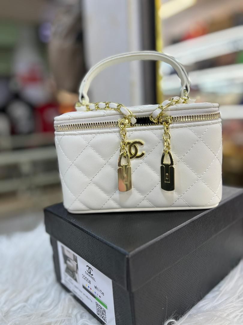 mini vanity box shape made of synthetic leather featuring Chanel's signature diamond quilting.