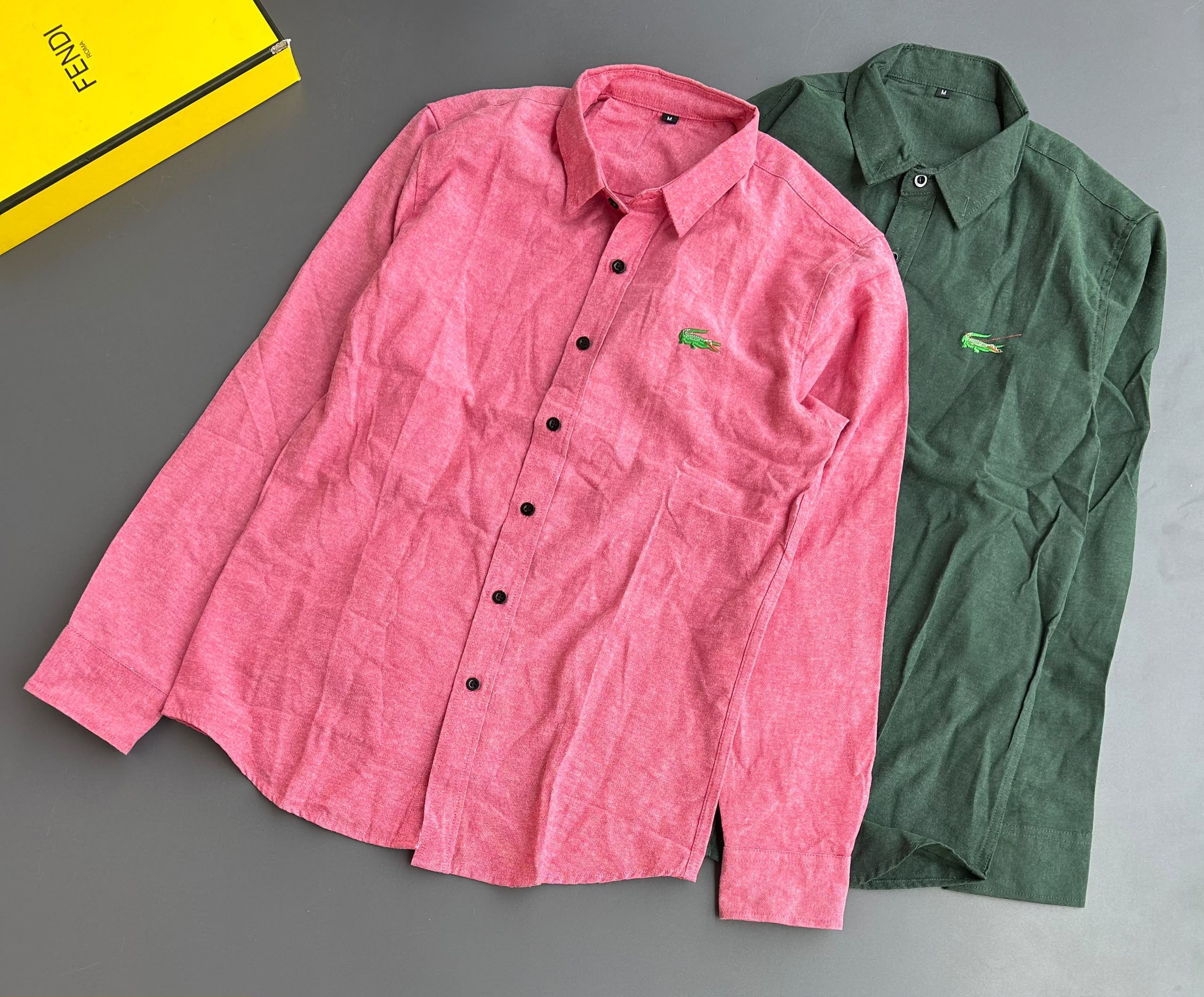 Lacoste Men's Long-Sleeve Cotton Linen Shirts feature lightweight breathable fabric, a button-down front, pointed collar, and the signature crocodile chest logo, available 